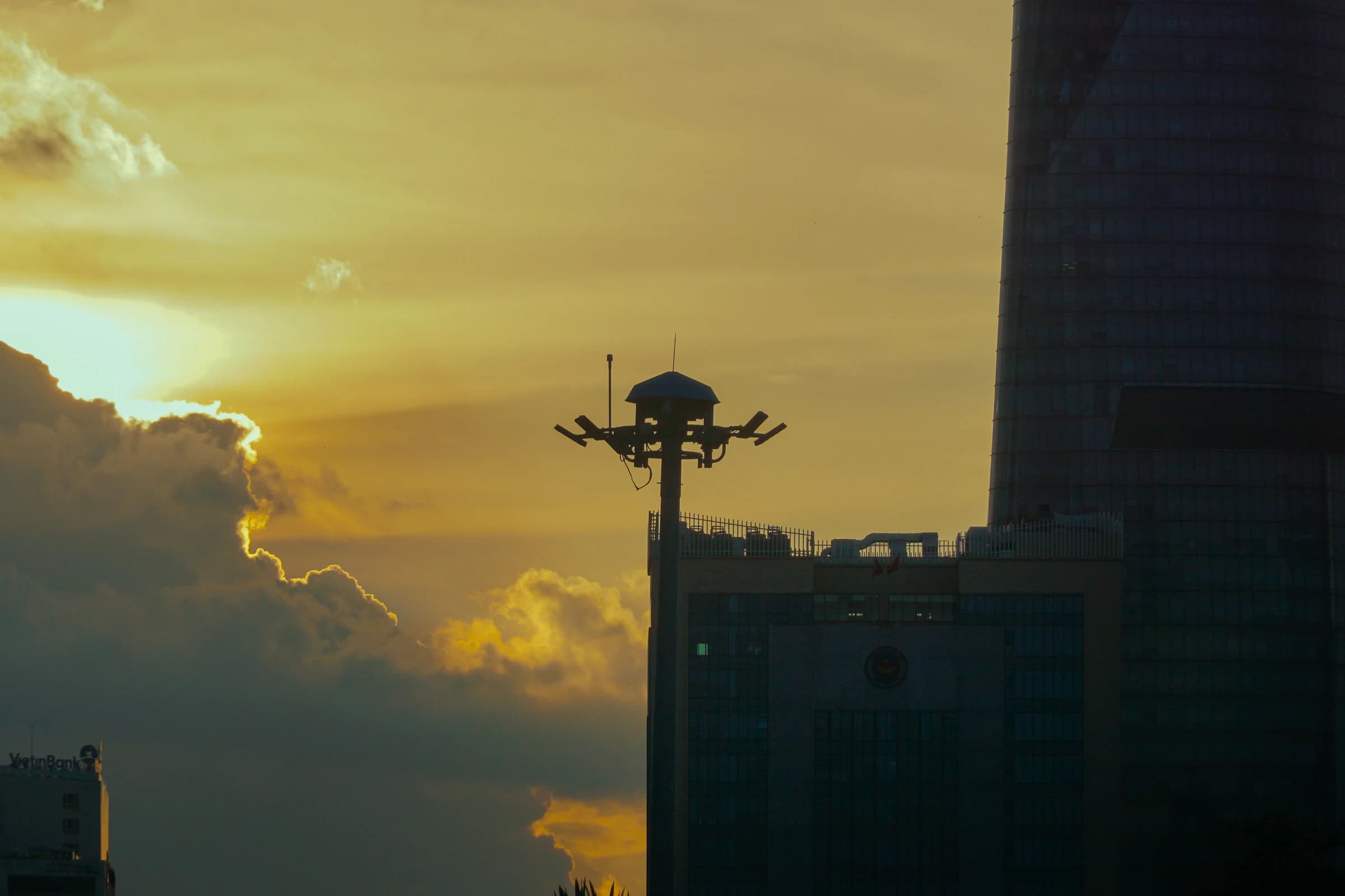 A high-rise and golden clouds in Ho Chi Minh City at sunset