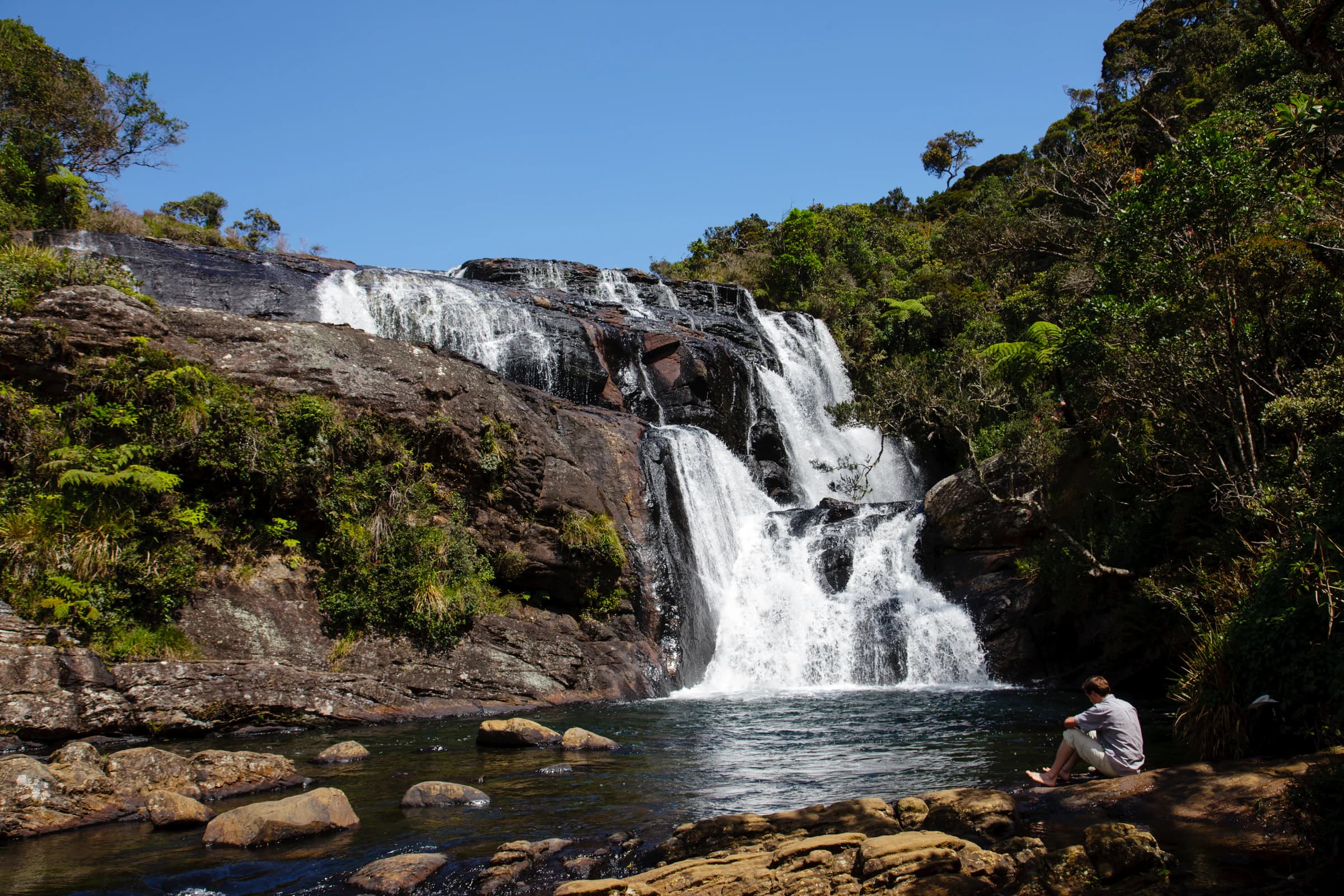 A waterfall surrounded by Sri Lankan hill-country greenery