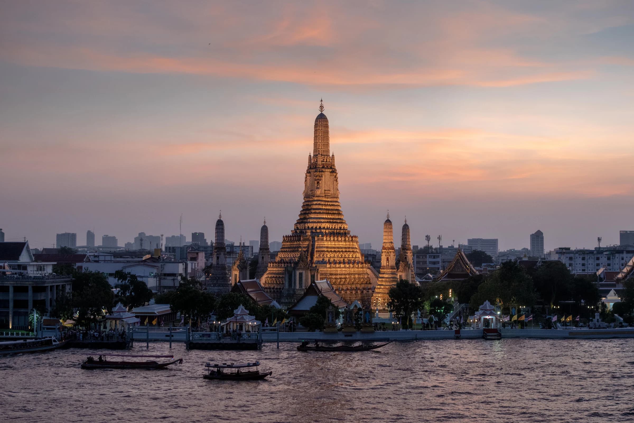 Wat Arun beside the Chao Phraya River at sunset