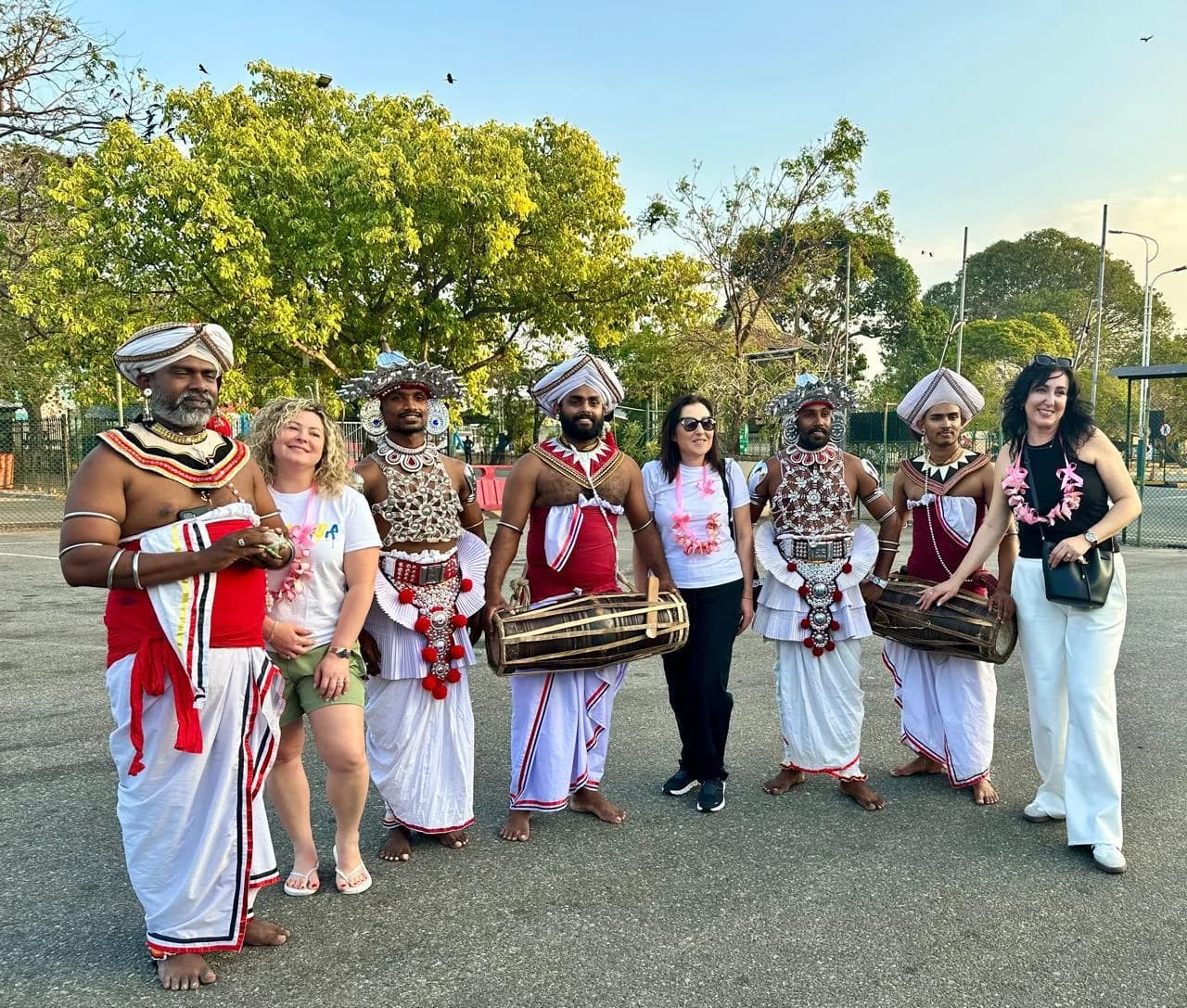 Women travellers in Sri Lanka with traditional performers